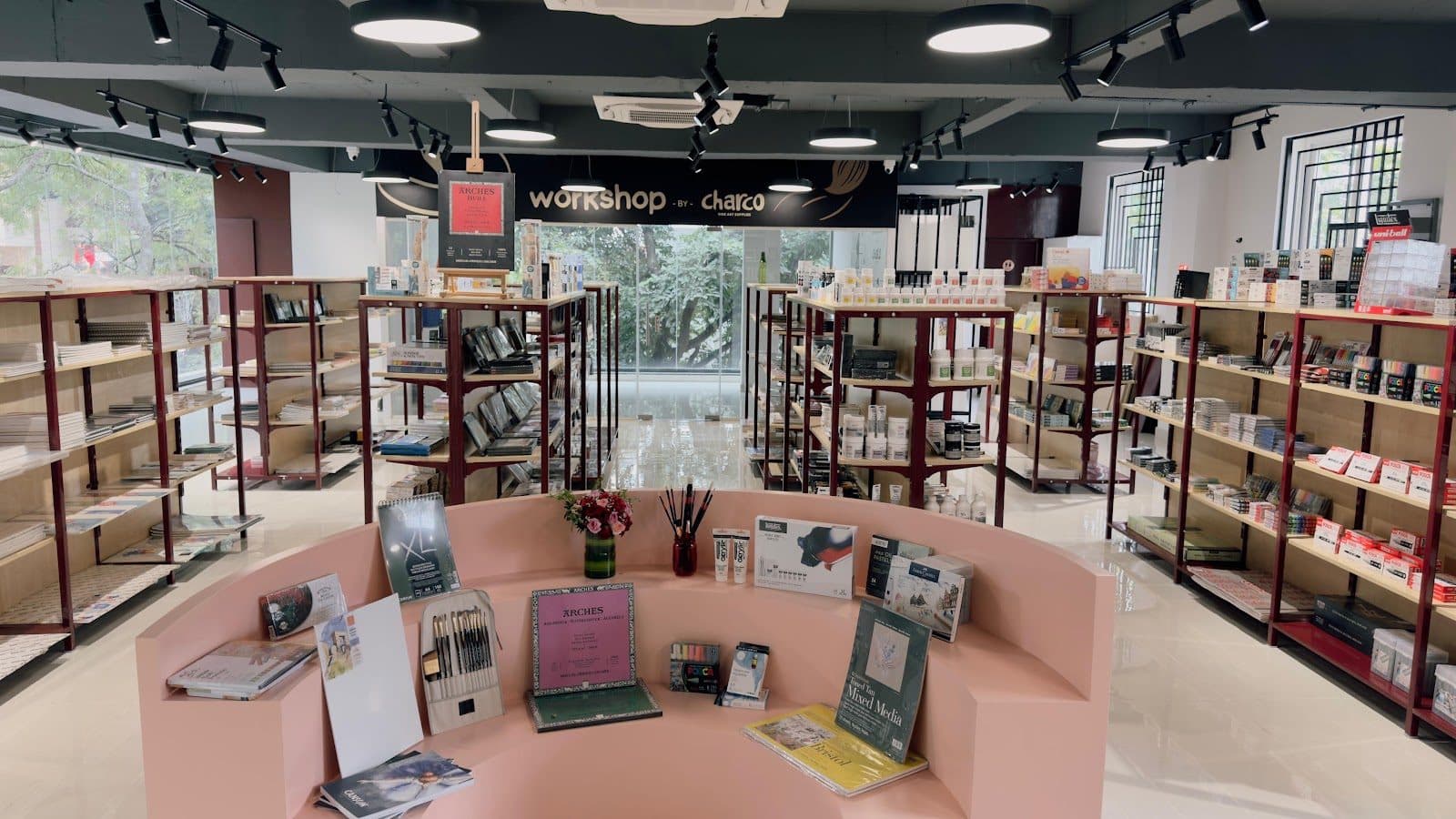 Inside Charco Fine Art Supplies: shelves of paints, pads and papers around the workshop area
