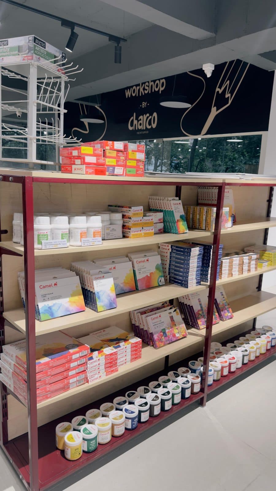 Paint and pad shelves beneath the workshop sign